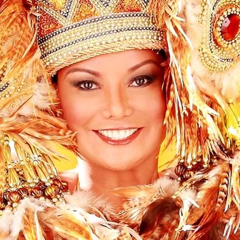 Bessie Badilla in a gold feathered Carnival headdress